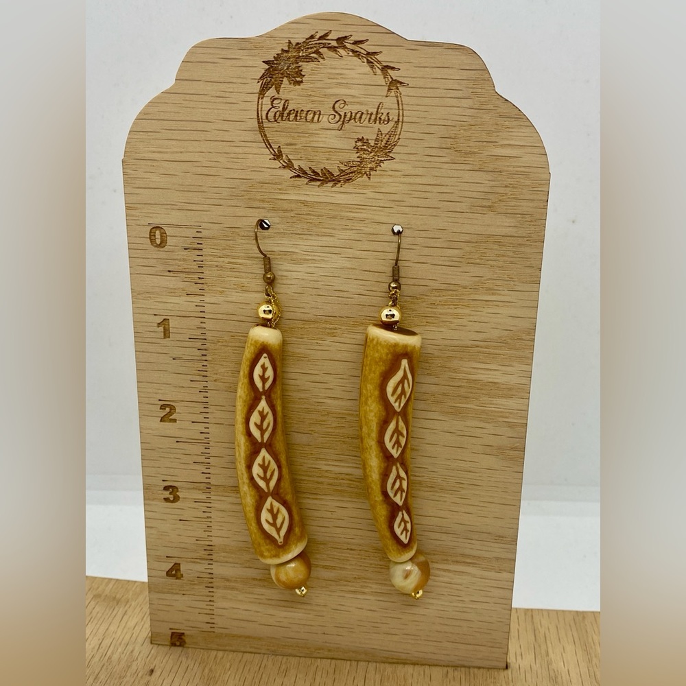 Vintage handmade dangle earrings with leaf accents